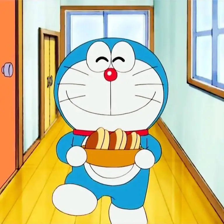 Gambar keluarga bahagia menonton Doraemon bersama.